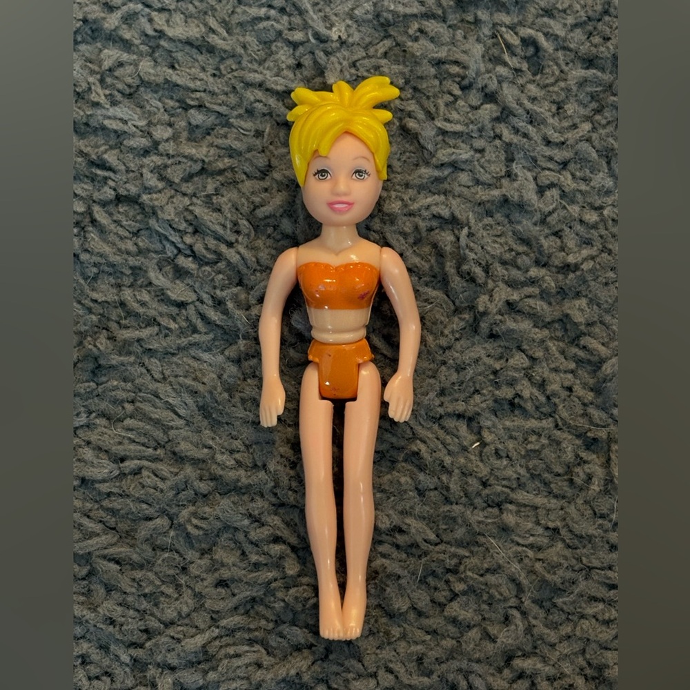 Lightly used Polly Pocket with a blonde spikey updo and orange undergarments